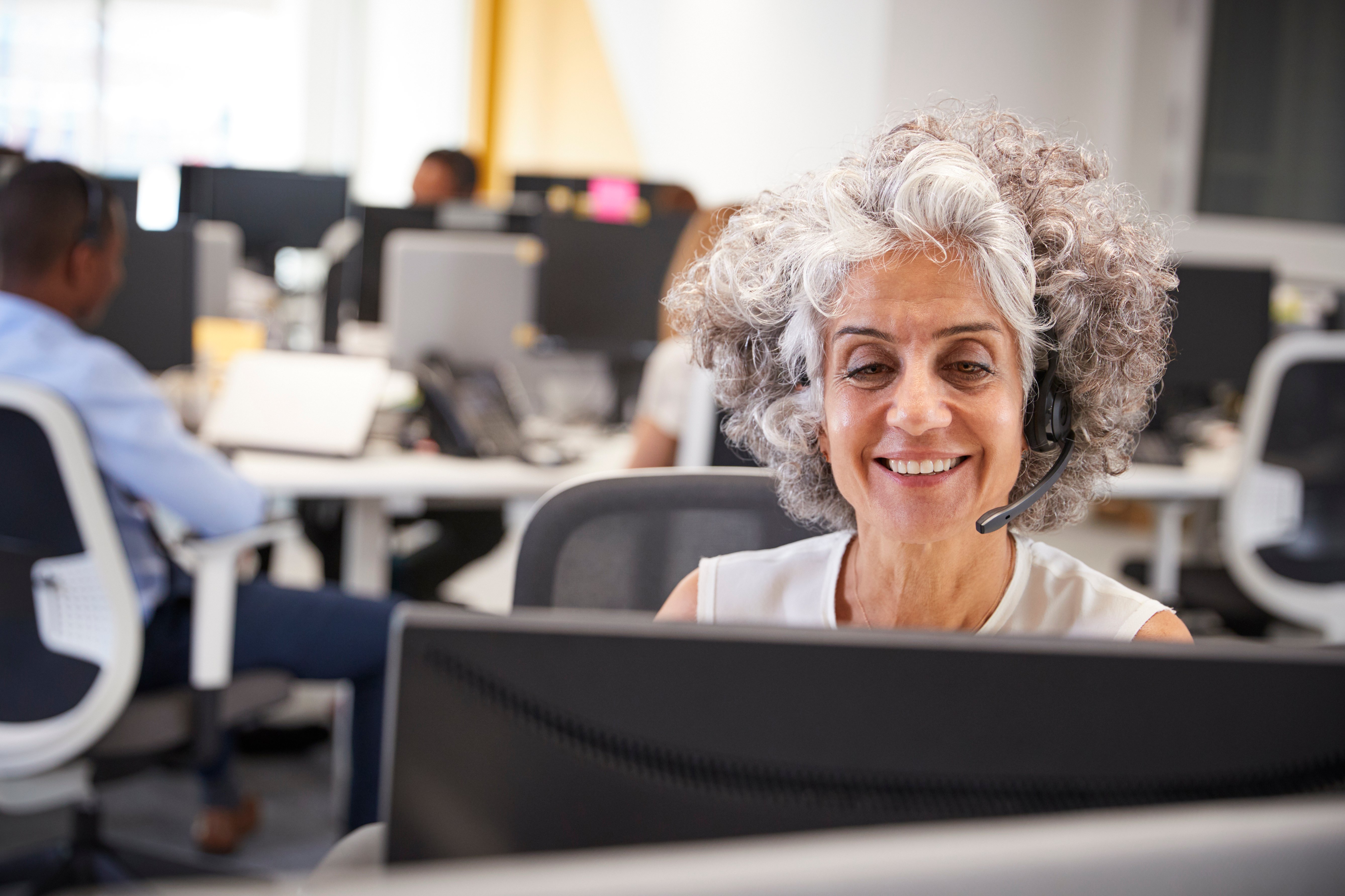 middle-aged-woman-working-at-computer-with-PB9QVGP